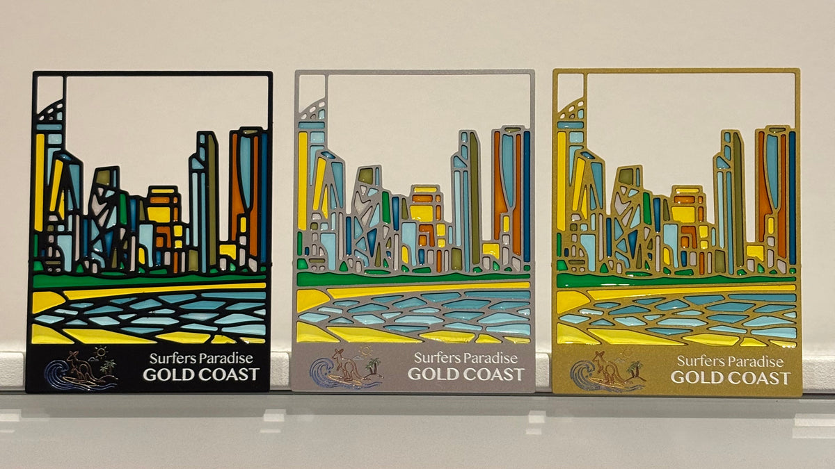 Gold Coast keepsakes in black, silver and gold frames, glowing in the light